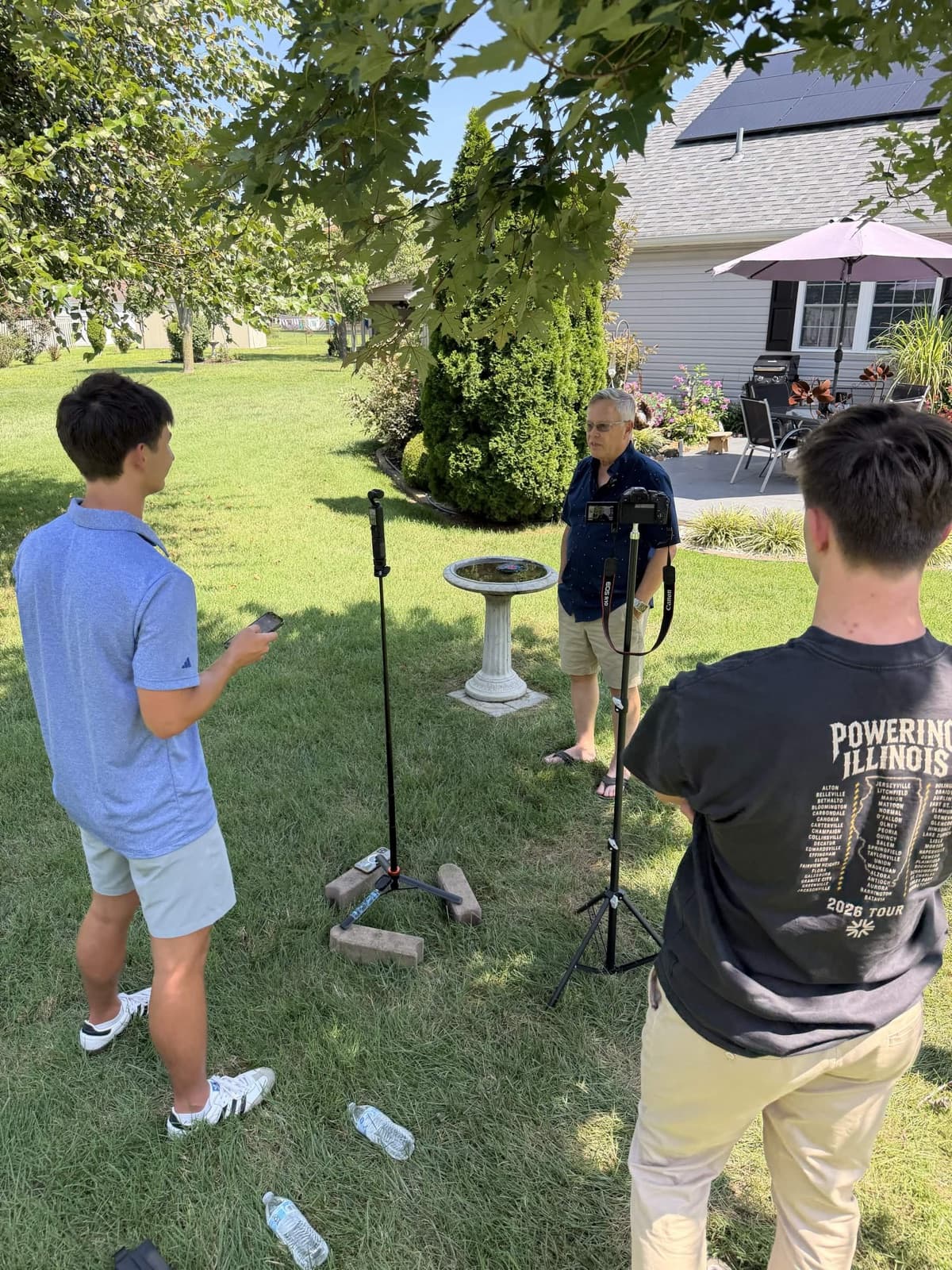 Two Driftlss team members directing an on-camera interview with a business owner during an on-location film day